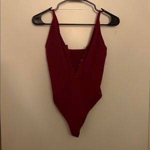 A magenta Strachey bodysuit that can be hooked up